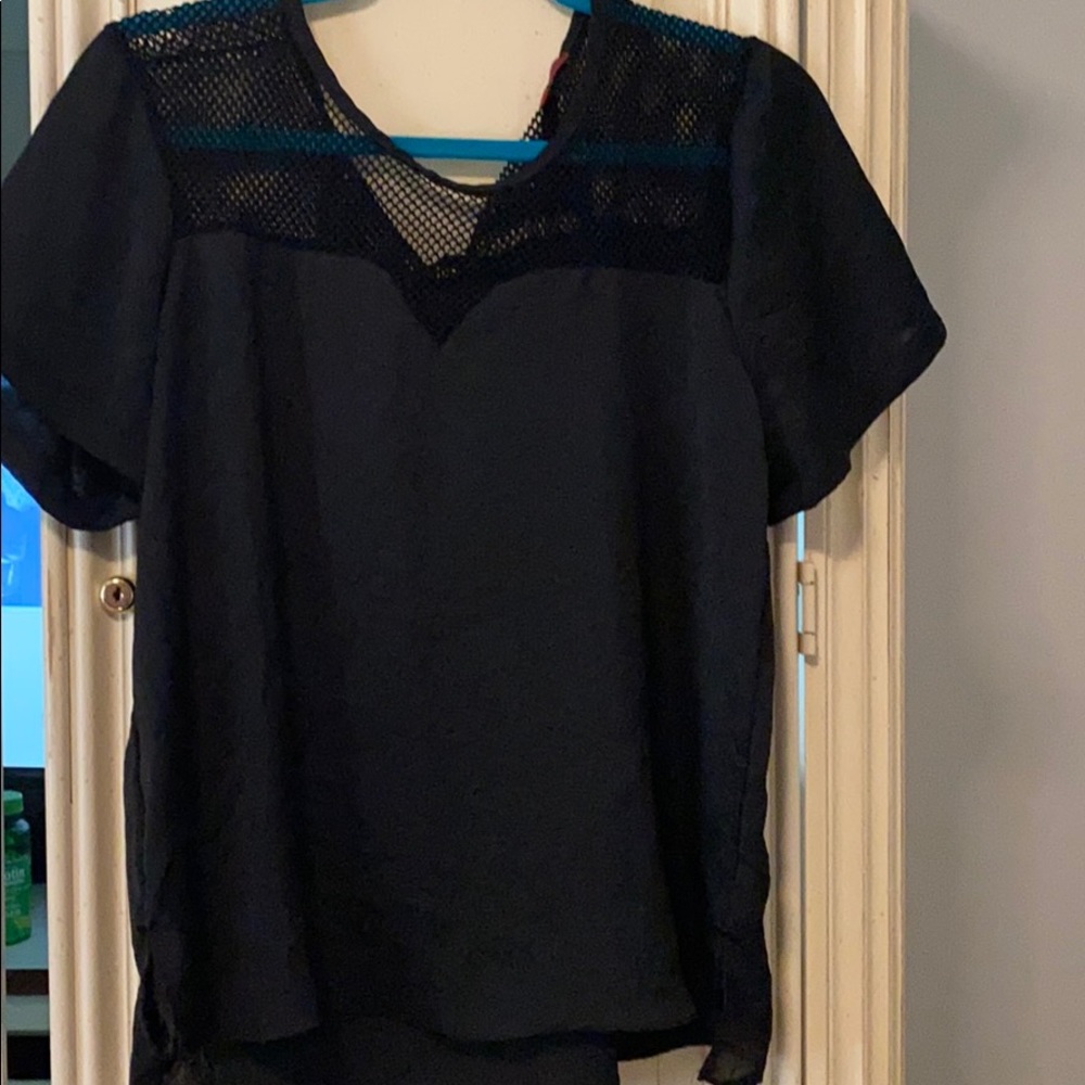 black shirt with fishnet top across the shoulders